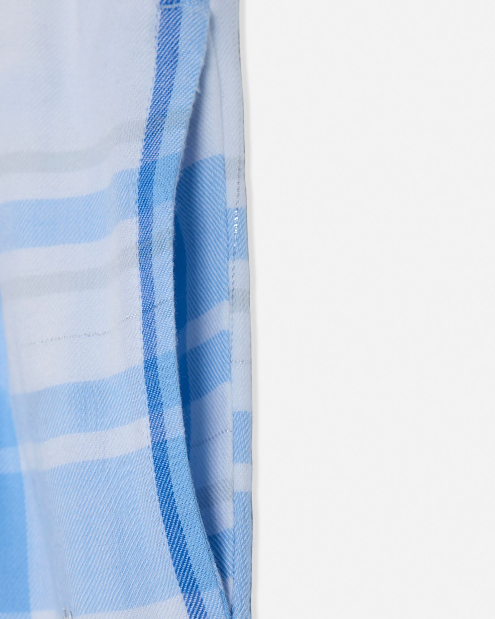 Close-up of a blue and white checkered fabric on a light gray background