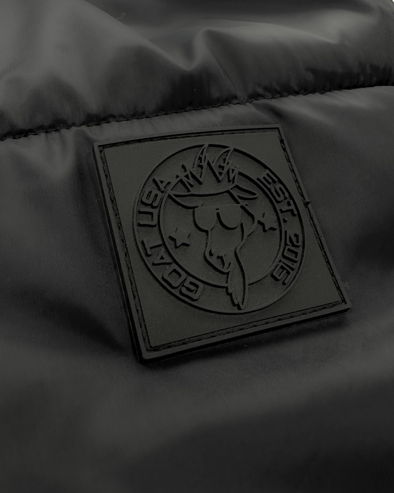 Close up of patch on black Women's Puffer Jacket#color_black