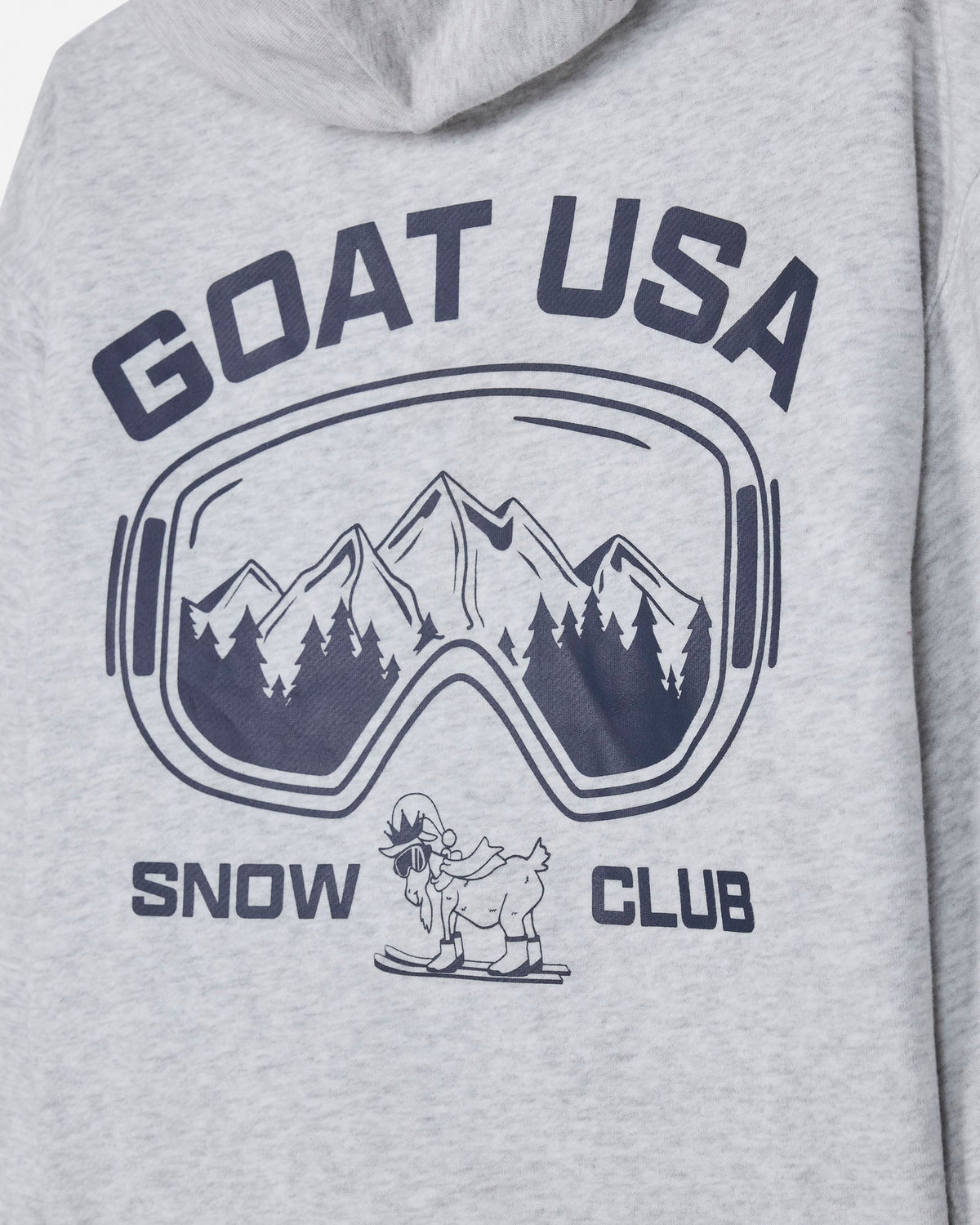 Close-up of a light heather gray hoodie featuring a dark navy graphic print with the text 'GOAT USA' and 'SNOW CLUB' surrounding a mountain scene inside ski goggles and a small cartoon goat on a snowboard.