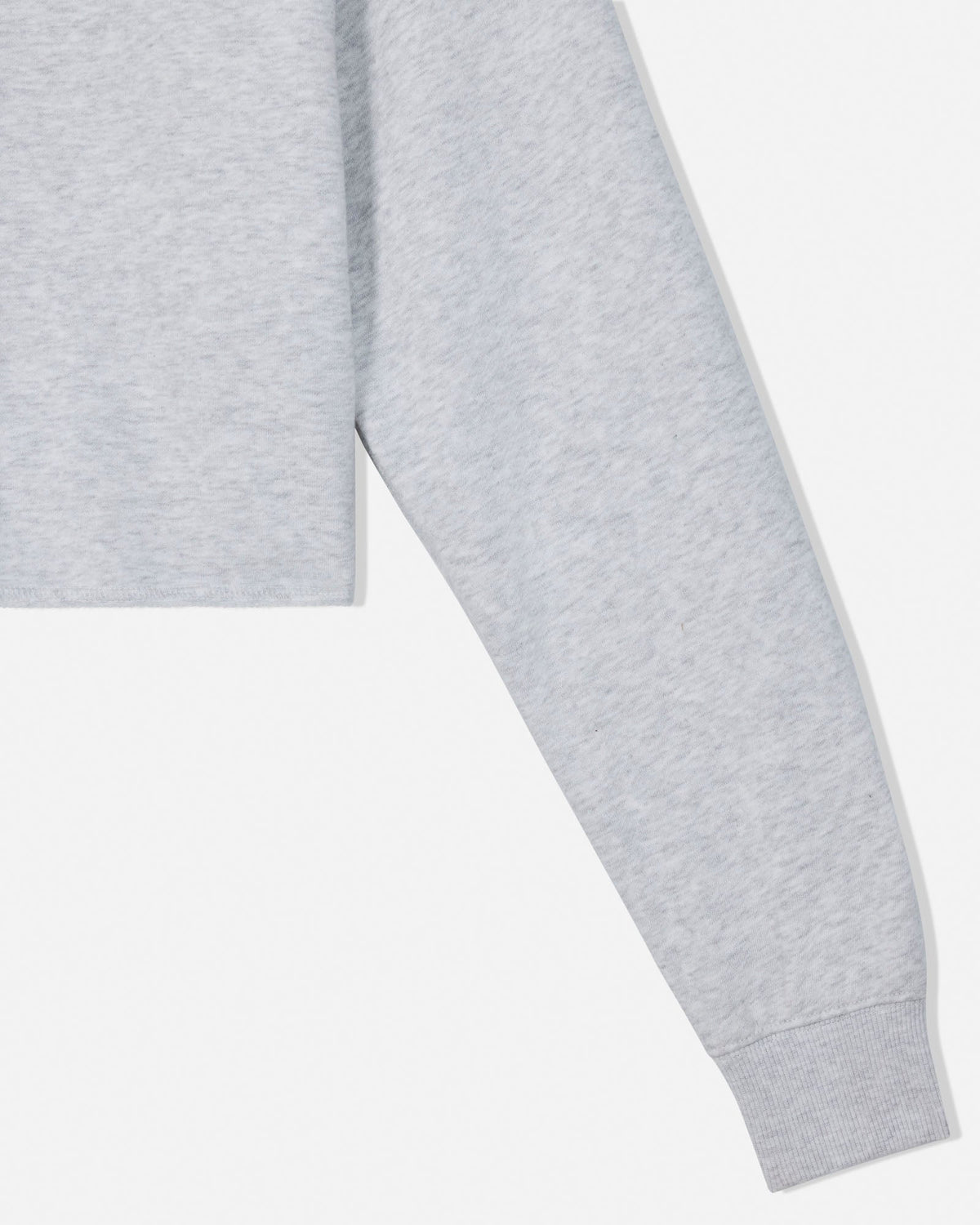 Close-up of a light gray heather sweatshirt sleeve with a ribbed cuff, shown against a plain white background.
