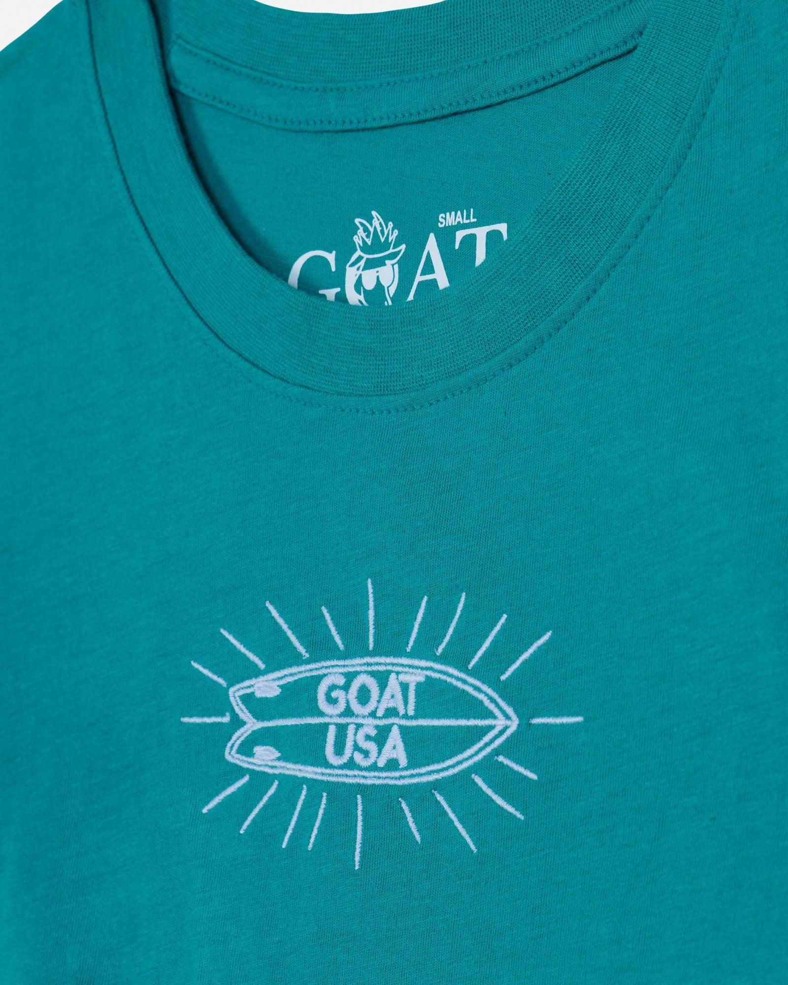 Teal tank top with white graphic and 'GOAT USA' text