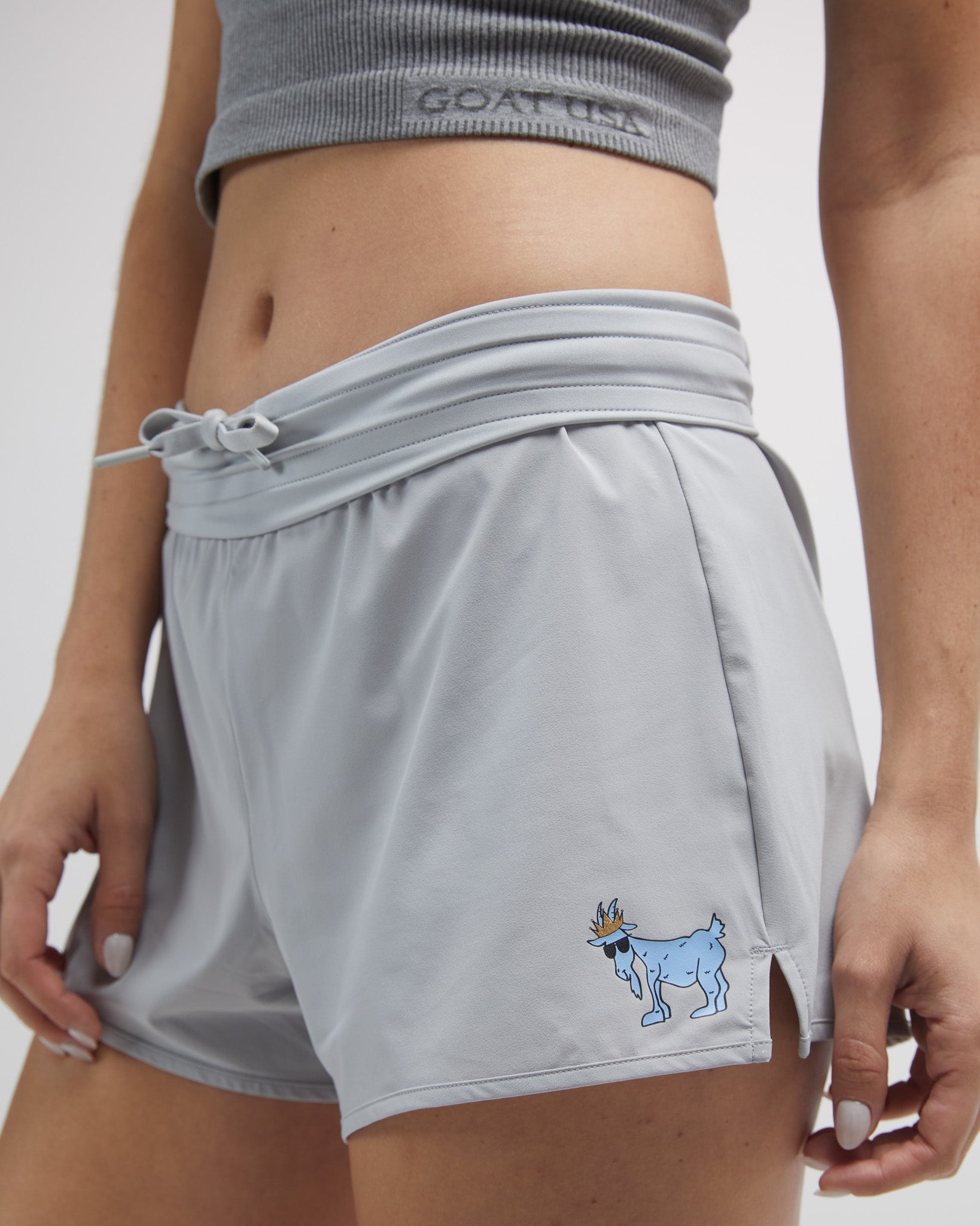 Close up of person wearing the gray women's athletic shorts#color_gray