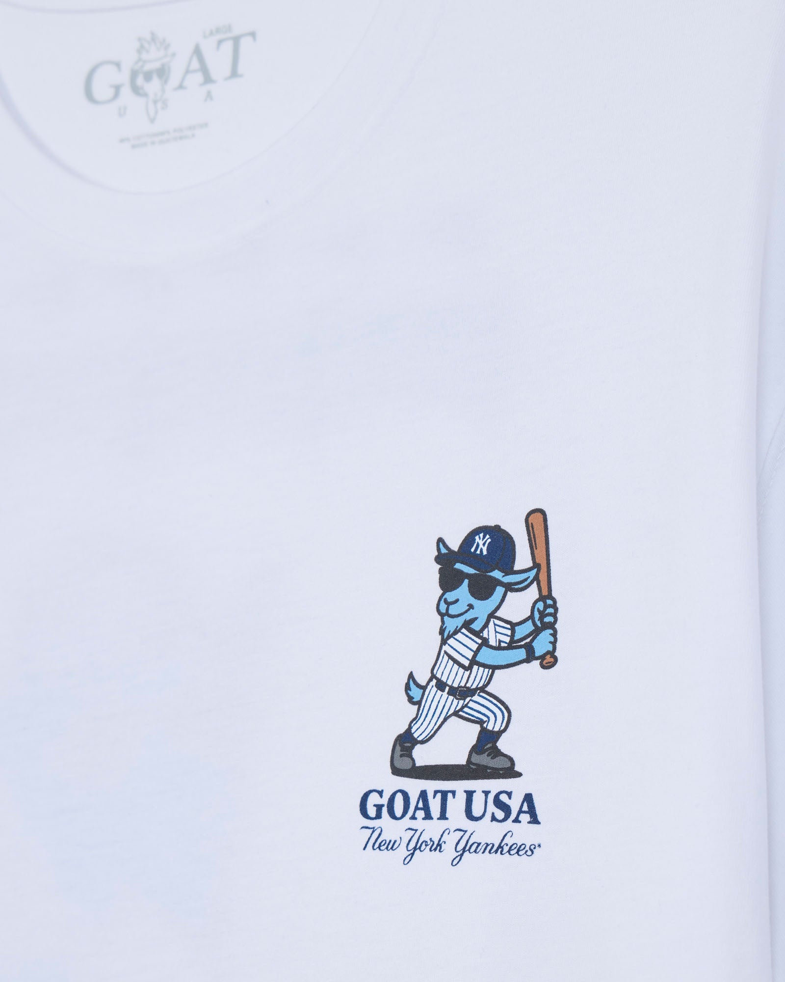 White short-sleeve t-shirt featuring a blue cartoon goat baseball player holding a bat, with 'GOAT USA New York Yankees' printed below.#color_white