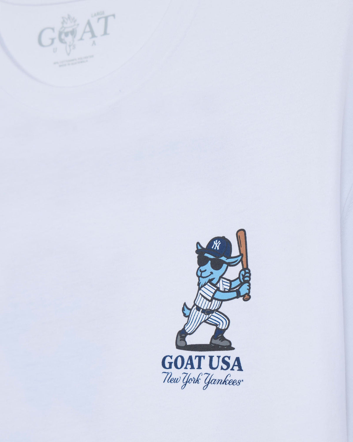 White short-sleeve t-shirt featuring a blue cartoon goat baseball player holding a bat, with 'GOAT USA New York Yankees' printed below.